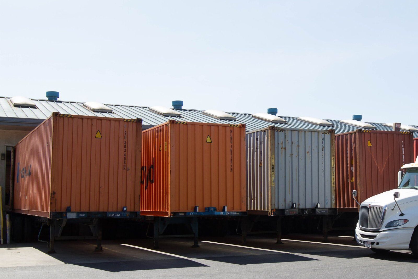 Loaded containers on chassis staged at the warehouse dock
